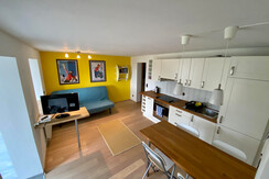 Combined kitchen and living room with sofa bed and flatsceen TV